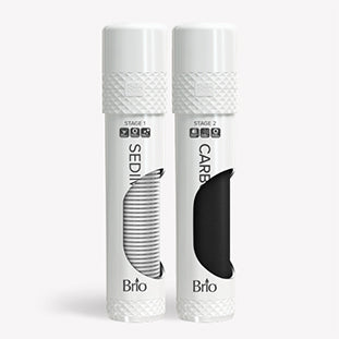 Two white cylindrical water filter cartridges labeled Stage 1 Sediment and Stage 2 Carbon by Brio, each with a textured cap and a visible section showing their filter materials.
